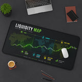 Liquidity map desk mat on a dark surface with office items.