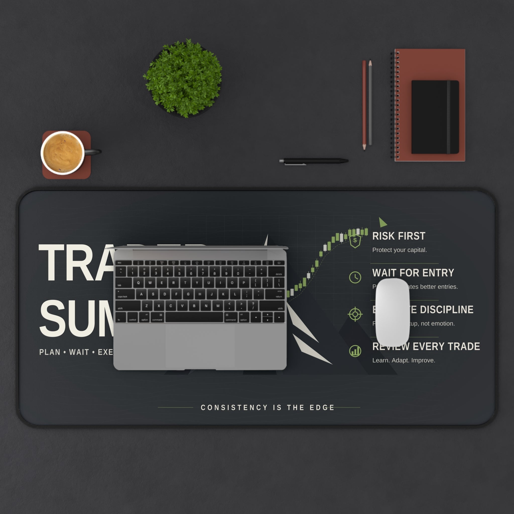 Desk setup with a laptop, mouse, and stationery on a dark surface